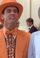 Jim Carrey in an iconic orange suit, capturing the comedic essence of "Dumb and Dumber" with a memorable expression.