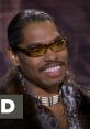 Pootie Tang smiling in stylish eyewear, showcasing his iconic look from the cult classic comedy film.