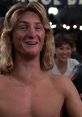 Celebrating youth and fun, a character from "Fast Times at Ridgemont High" laughing in a lively party scene.