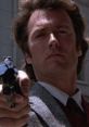 Clint Eastwood as Dirty Harry aiming a revolver, showcasing his iconic tough cop persona in a classic 1970s film scene.