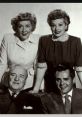 Classic "I Love Lucy" cast photo featuring Lucille Ball, Desi Arnaz, Vivian Vance, and William Frawley in elegant attire.