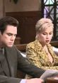 Jim Carrey and Laura Dern in a tense courtroom scene from Liar Liar, highlighting the film's comedic legal battles.