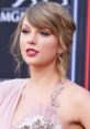 Taylor Swift showcasing glamorous makeup and elegant fashion at a red carpet event, highlighting her iconic style.