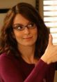 Liz Lemon giving a thumbs up, showcasing her iconic style and personality from "30 Rock." A moment of enthusiasm captured.