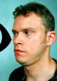 Pensive man with short hair in a black shirt, featuring a vibrant background, evoking themes from "Peep Show 2.