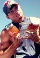 Young man in a sleeveless shirt holding three jars, showcasing a Louisiana redneck lifestyle outdoors.