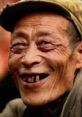 Elderly man smiling warmly, showcasing unique character and charm, wearing a hat and displaying a friendly expression.