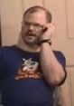 Man wearing a T-shirt engages in animated conversation on the phone, capturing a humorous moment from Tourettes Guy 2.