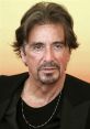 Al Pacino with tousled hair and a classic black outfit, exuding charisma and intensity in a candid portrait.