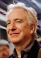 Alan Rickman smiling, known for his iconic roles in film and theater, showcasing his signature silver hair and charismatic presence.