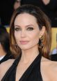 Angelina Jolie showcases elegant style with striking earrings, a glamorous look at a red carpet event.