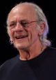 Christopher Lloyd smiles during a public appearance, showcasing his iconic style and charisma. Renowned actor and director.