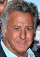 Dustin Hoffman smiles warmly, showcasing his signature style and distinguished features at a glamorous event.