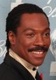 Eddie Murphy smiling in a black tuxedo, showcasing his iconic style at an award event.