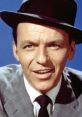 Frank Sinatra smiling, wearing a black hat and gray suit, embodying classic Hollywood charm and elegance.