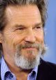 Jeff Bridges smiling in a casual setting, showcasing his signature gray beard and relaxed demeanor.