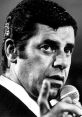 Jerry Lewis performing on stage, passionately engaging the audience with a microphone in hand. Iconic comedic expression.