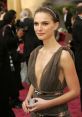 Natalie Portman stunning in a plunging neckline dress, showcasing elegance at a prestigious red carpet event.