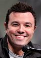 Seth MacFarlane smiling while speaking at an event, showcasing his engaging personality and charisma.