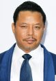 Terrence Howard in a stylish blue suit and tie, showcasing his signature grooming and confident expression at an event.