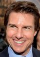 Tom Cruise flashes a charming smile at a glamorous event, showcasing his iconic style and charisma on the red carpet.