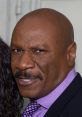 Ving Rhames smiling confidently in a formal outfit, showcasing his iconic style and presence.