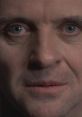 Close-up of Dr. Hannibal Lecter, showcasing his intense gaze and subtle smile, embodying his chilling yet captivating persona.