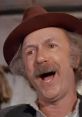 Cheerful man with a mustache and hat, embodying the playful spirit of Grandpa Joe from classic family films.