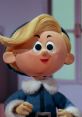 Hermey the Elf smiles cheerfully, showcasing his signature blonde hair and blue outfit with white fur trim.