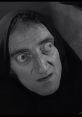 Igor's intense gaze and dramatic expression capture the essence of classic horror-comedy in vintage cinema.