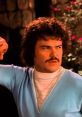 Nacho Libre character in retro clothing, showcasing a confident expression, surrounded by a vibrant, colorful backdrop.