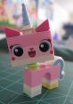 Colorful LEGO figure of Princess Unikitty with a blue horn, big eyes, and a cheerful expression, perfect for imaginative play.