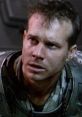 Private Hudson displays a tense expression, showcasing his fear and determination in a high-stress sci-fi environment.