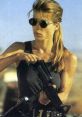 Sarah Connor in tactical gear, ready for action with a rifle, embodying strength and determination from the iconic film series.