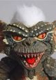 Vibrant close-up of a Gremlin from "Stripe And The Evil Gremlins," showcasing its mischievous expression and sharp teeth.