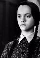 Wednesday Addams with two braids, wearing a vintage floral dress, showcasing her signature dark and mysterious expression.