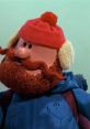 Yukon Cornelius, the iconic adventurer, known for his red hat and fluffy beard, embodies holiday spirit and bravery.