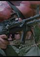 Heroic character from *Commando (1985)*, gripping a machine gun with intense focus and muscular build. Action-packed scene.