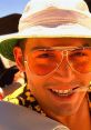 Smiling character in vibrant sunglasses and hat, exuding the wild spirit of "Fear and Loathing in Las Vegas.