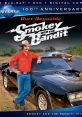 Burt Reynolds in "Smokey and the Bandit" (1977) with iconic black car, celebrating 100th anniversary of Universal Studios.