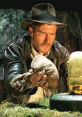 Indiana Jones prepares to replace a golden idol in a jungle setting, showcasing action and adventure from Raiders of the Lost Ark.