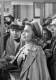 A woman at a bank counter, surrounded by anxious citizens, captures the emotional atmosphere of "It's a Wonderful Life.