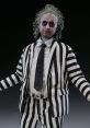 Beetlejuice figure in iconic black and white striped suit, showcasing the character's quirky and mischievous persona.