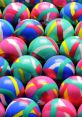 Colorful, patterned balls arranged closely together, showcasing vibrant hues of pink, blue, green, and yellow.