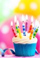 Colorful birthday cupcake topped with lit candles against a vibrant, festive background, perfect for celebrating special occasions.