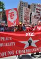 Young Communists rallying for peace and equality, holding signs advocating for immigrant rights and social justice.