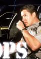 Police officer communicating via radio inside a patrol car, showcasing the essence of law enforcement in action.