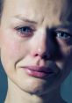 Emotional close-up of a woman crying, showcasing tears and a pained expression, evoking deep feelings of sadness.