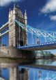 Tower Bridge in London, England, displays stunning architecture against a clear blue sky with reflections on the Thames.