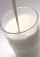 Creamy milk pouring into a glass, highlighting its rich texture and freshness. Perfect for smoothies or breakfast.